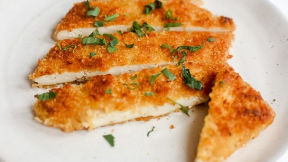 Plate of sliced tofu schnitzel.