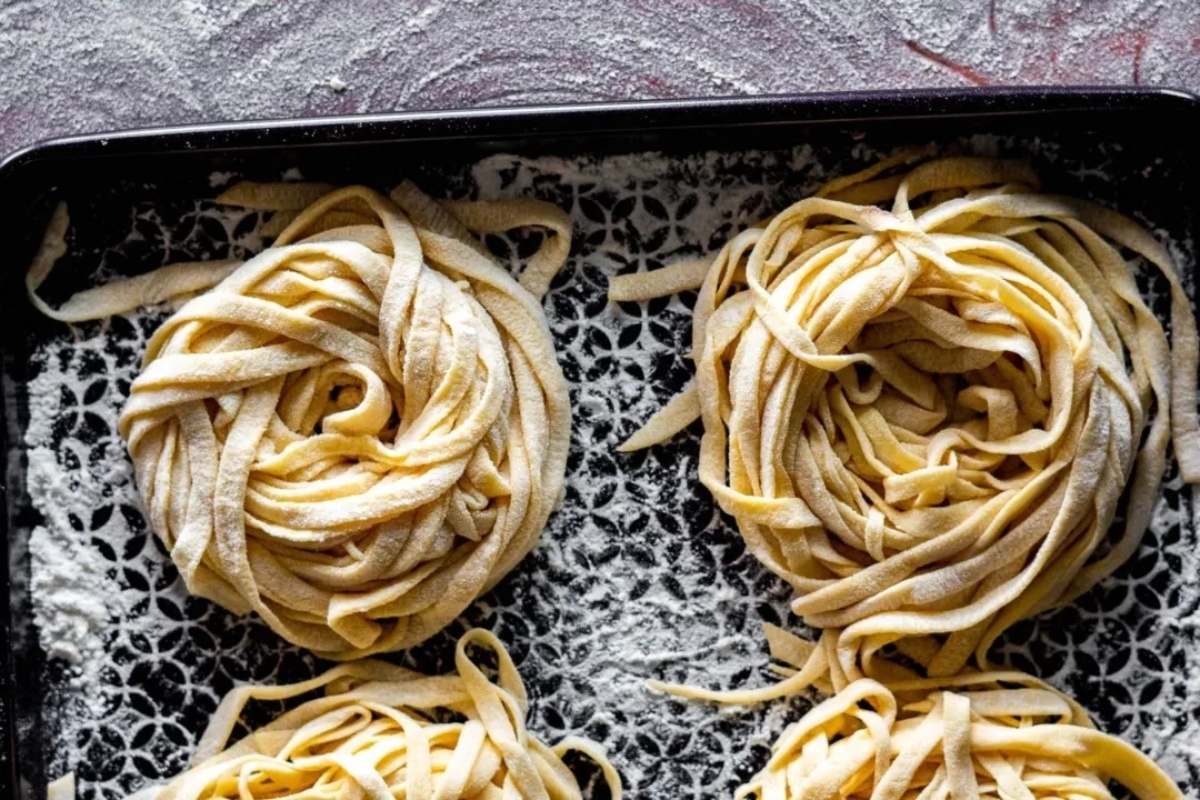 Fettuccine noodles on a baking sheet.