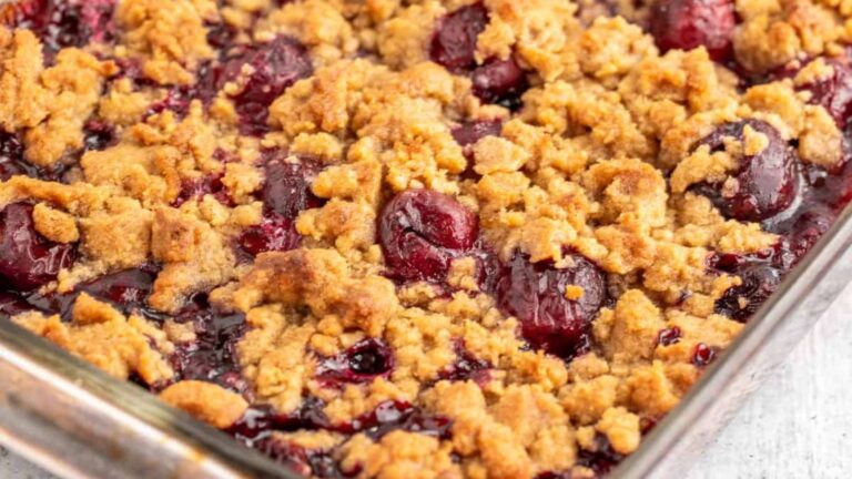 A freshly-baked cherry crumble in a glass dish.