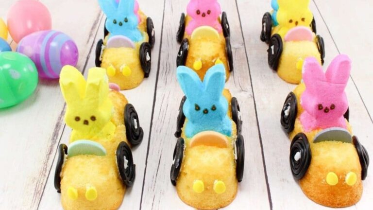 Colorful marshmallow Peeps in Twinkie cars with Oreo wheels, arranged as Easter treats.