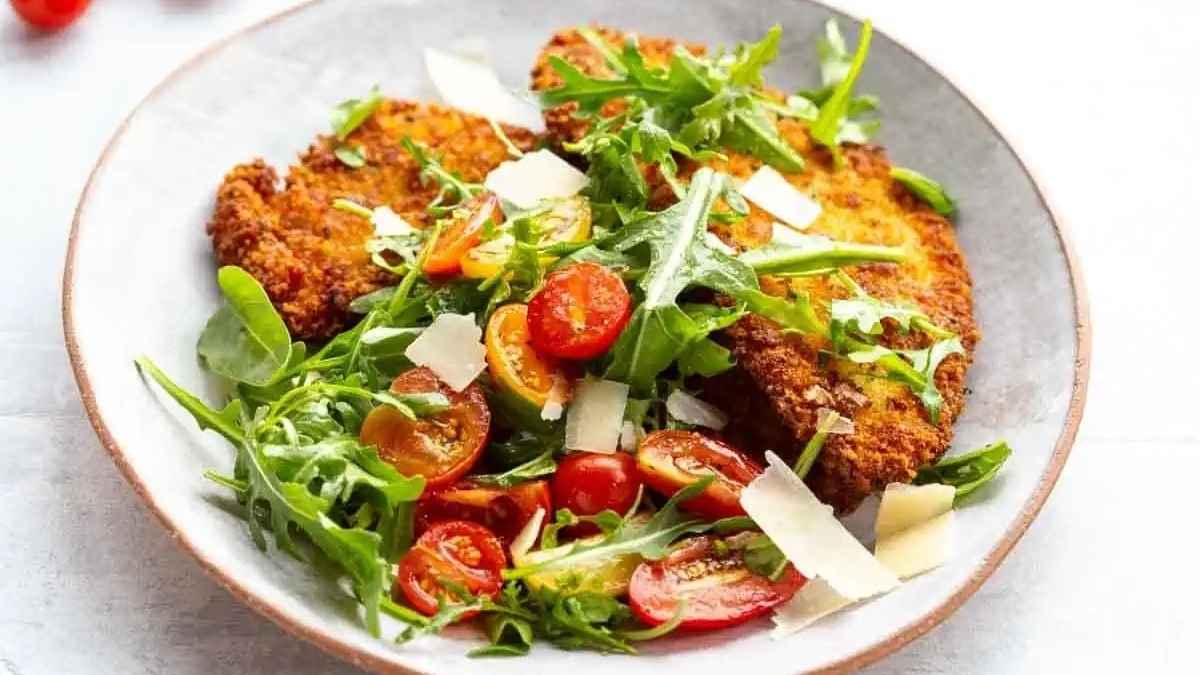 Crispy Chicken Milanese With Tomato Arugula Salad.