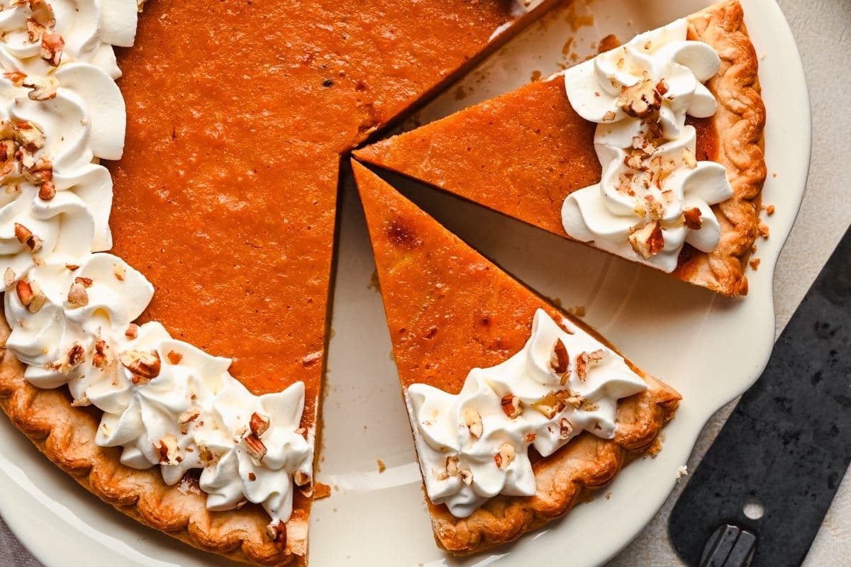 A plate of pie with a slice cut off.