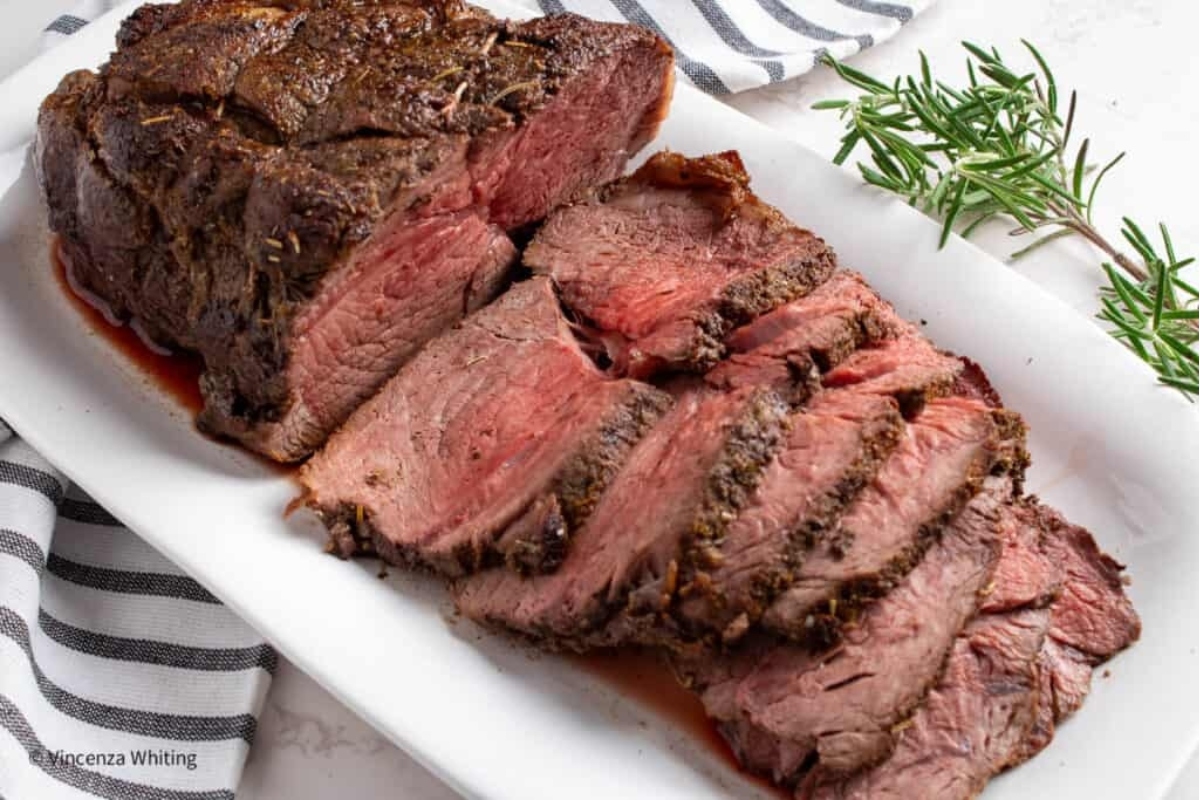 A sliced roast beef on a plate.