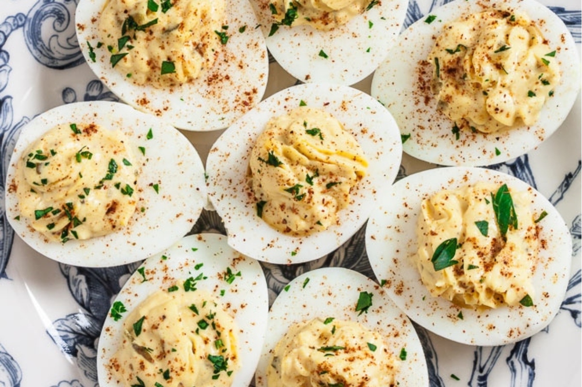 Deviled eggs on a blue and white plate.