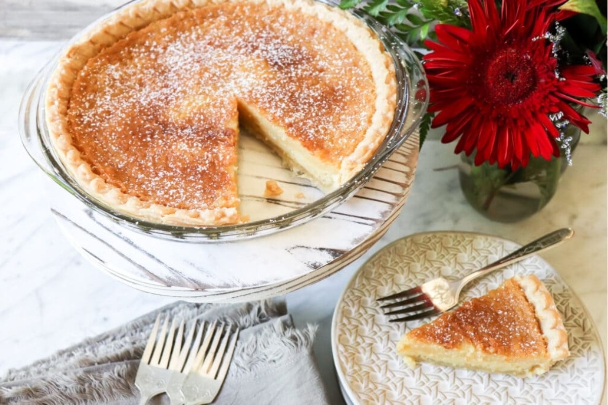 A pie on a plate with a slice taken out.
