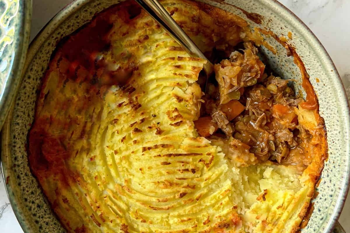 A bowl of food with a spoon.