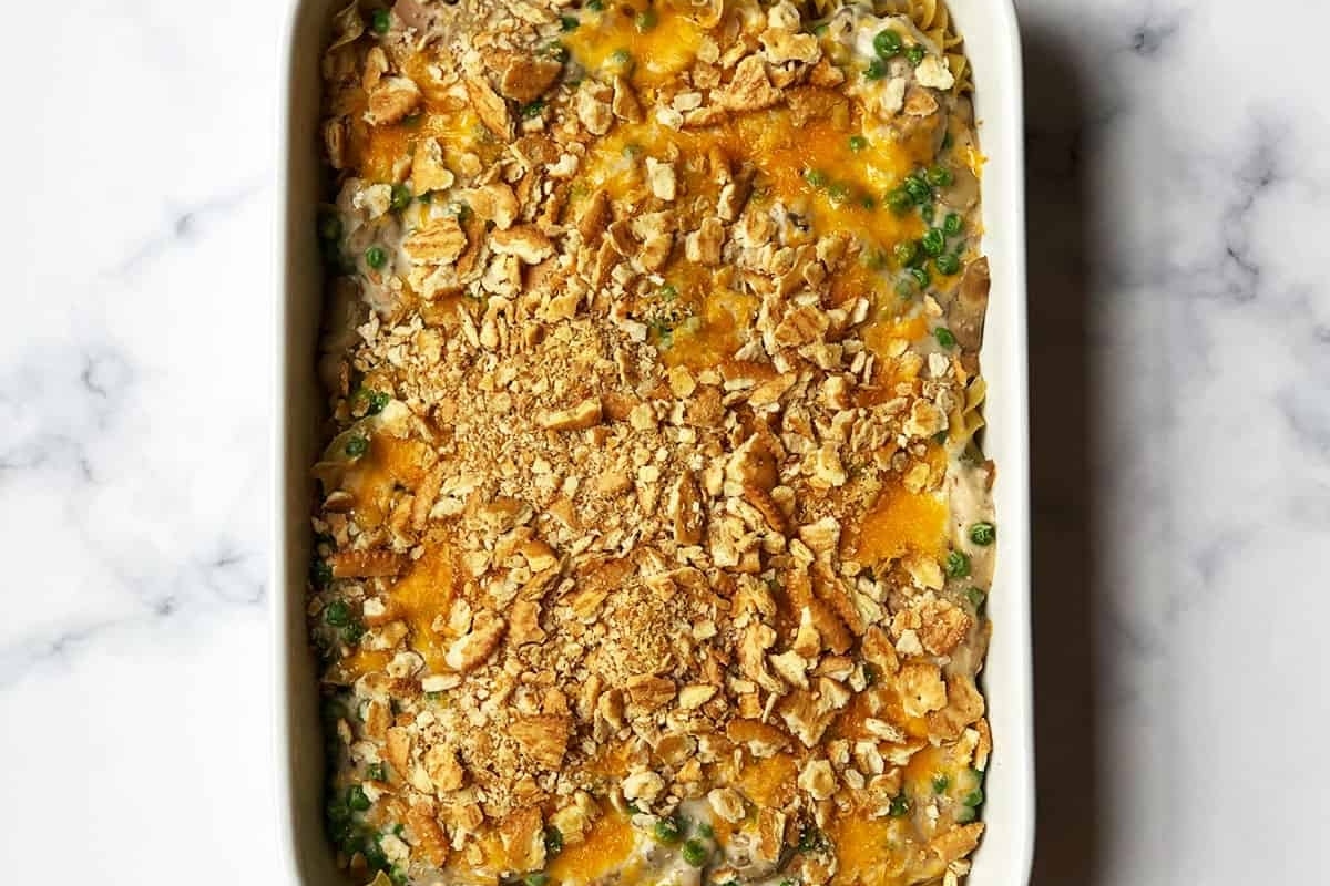 A casserole dish filled with broccoli and peas.