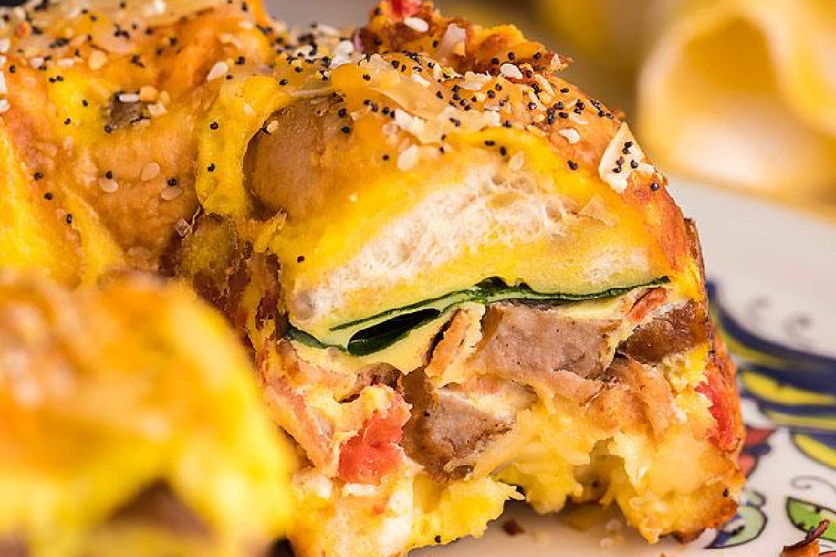 A slice of Loaded bagel breakfast on greens.