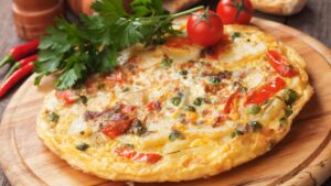 spanish omelet with fried potato and vegetables
